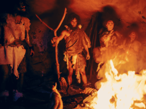 people celebrating Samhain around a bonfire dressed in animal skins