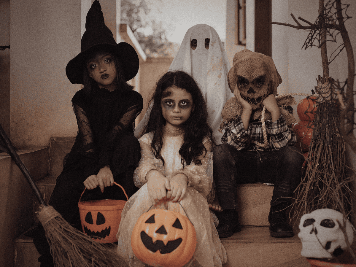 four kids in spooky Halloween costumes